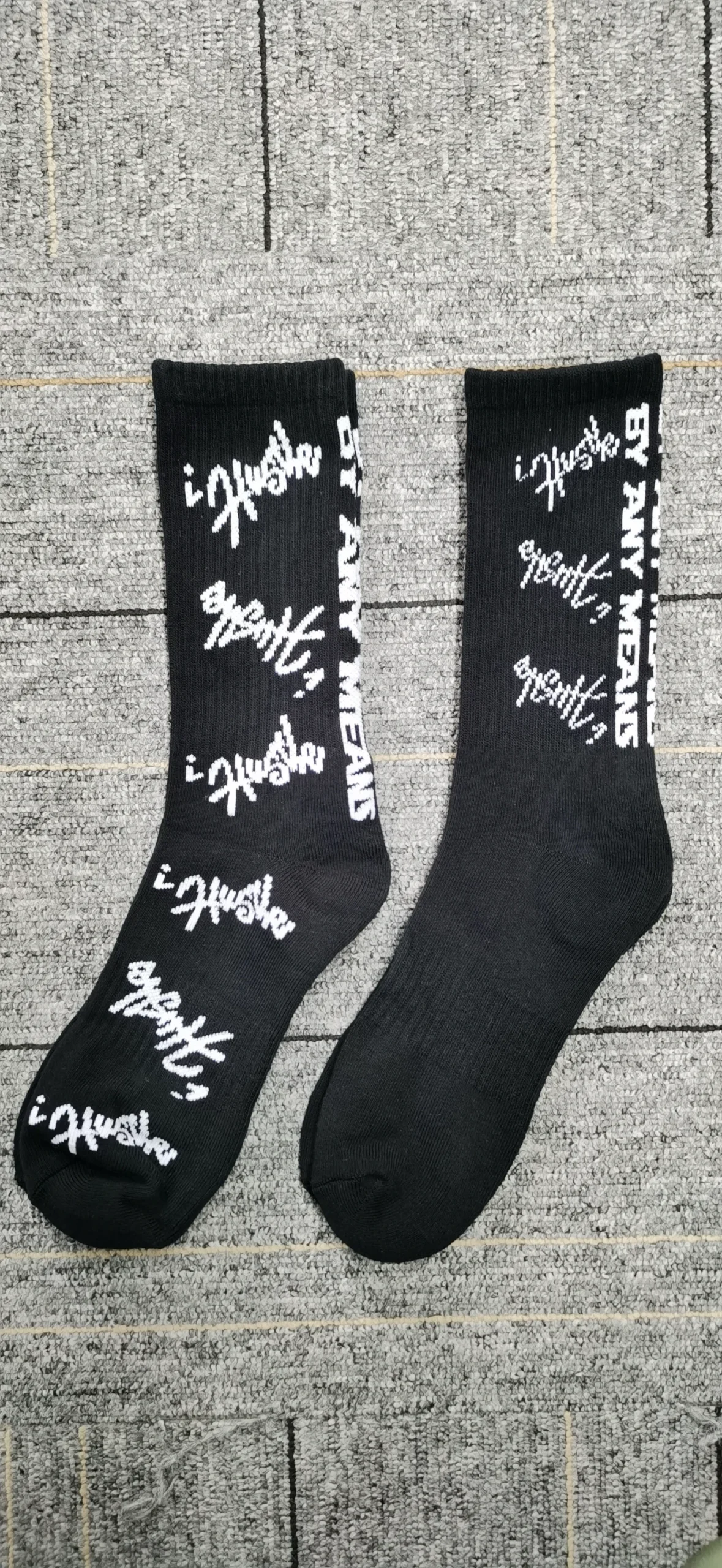 Black crew socks with white graffiti-style text design