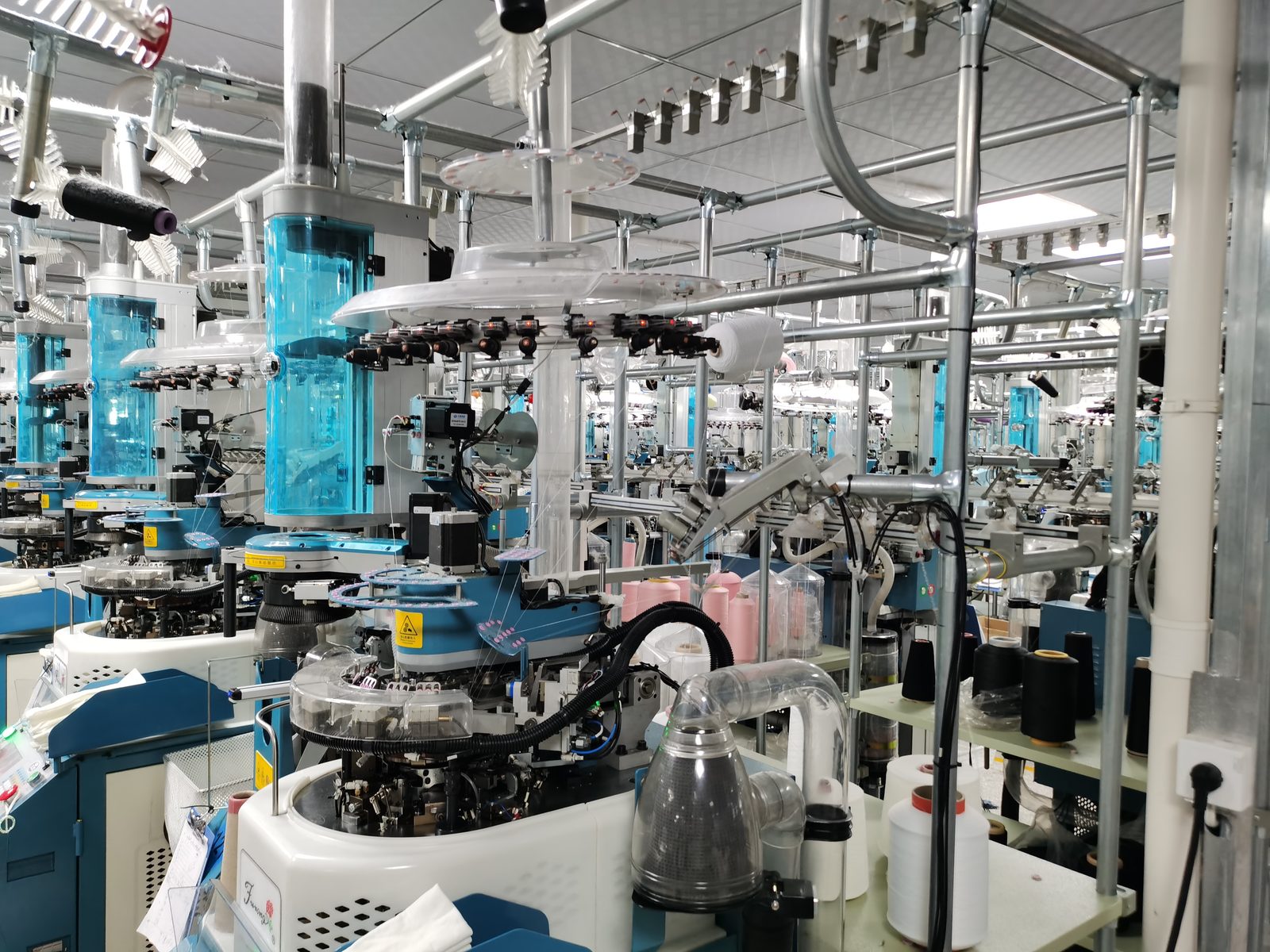 Factory workshop with sock knitting machines