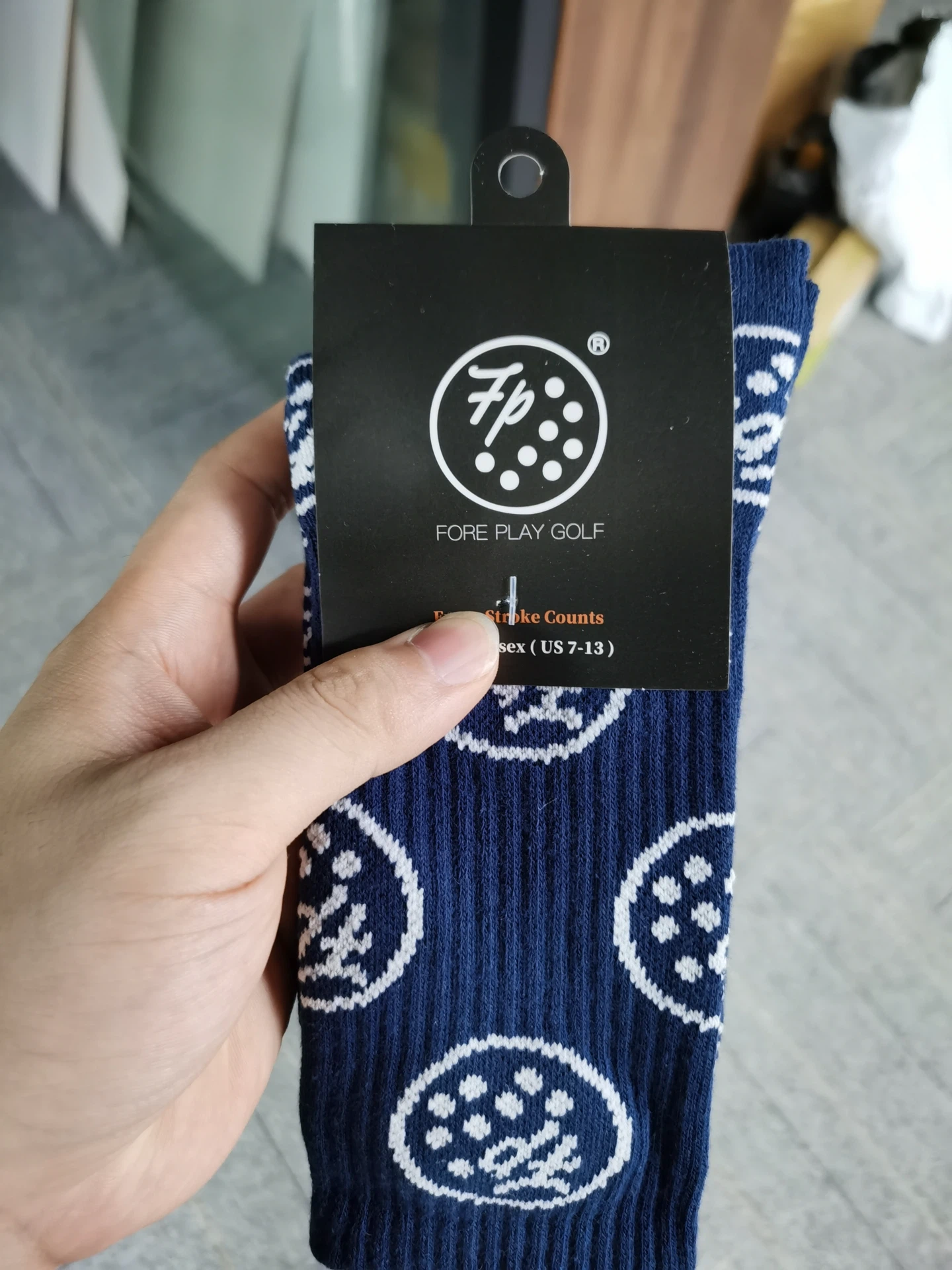 Custom golf socks with repeating golf ball pattern and custom hang tag - navy blue with white FP logo