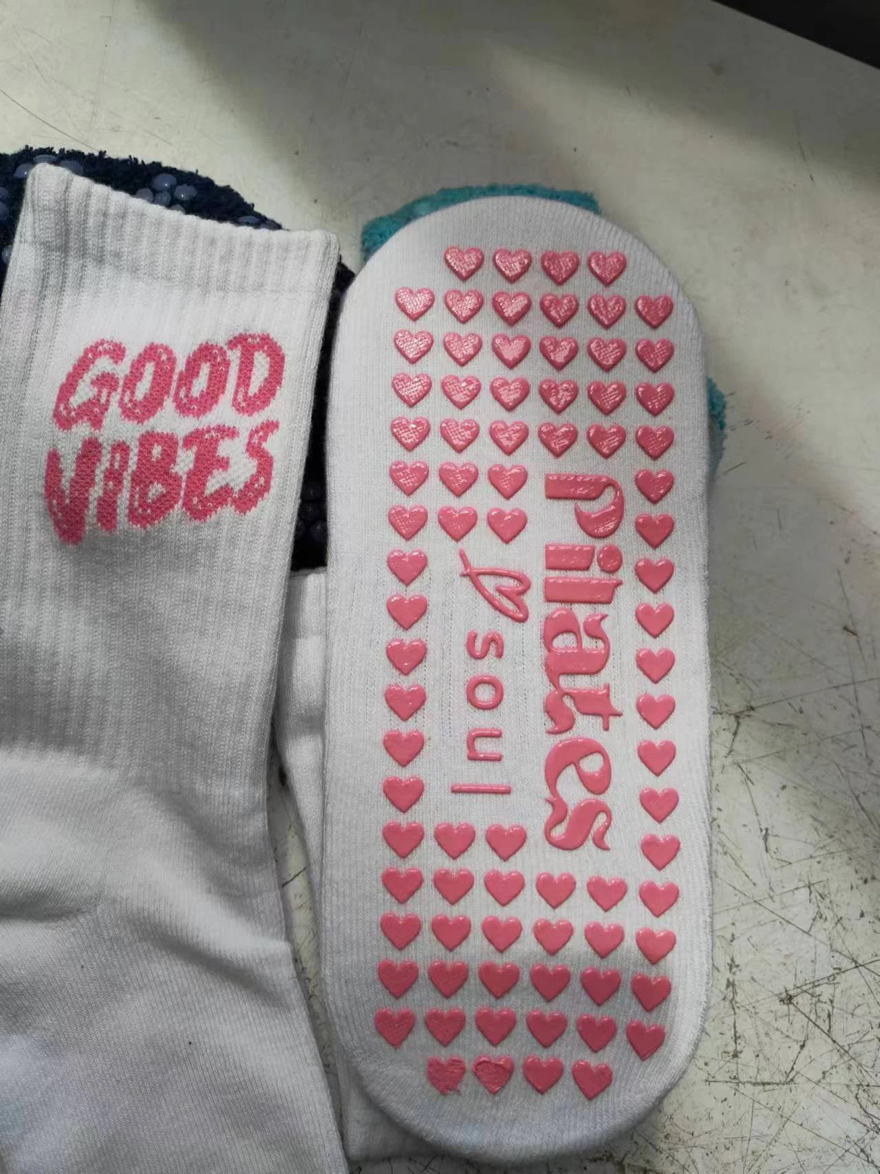 Pink heart-shaped grip dots on Pilates socks